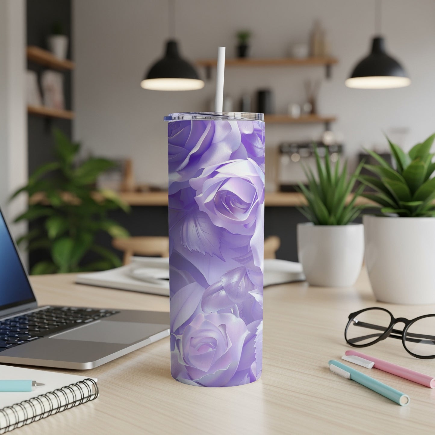 Purple floral tumbler with straw on a desk.