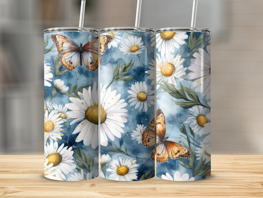 Three tumblers with white daisies and butterflies on a blue watercolor background.