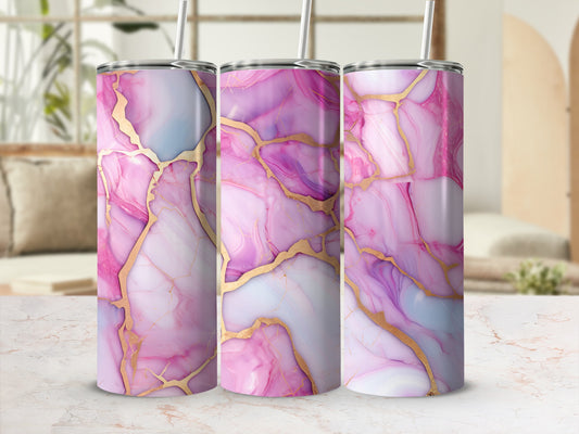Three pink and blue marbled tumblers with gold veins on a counter.