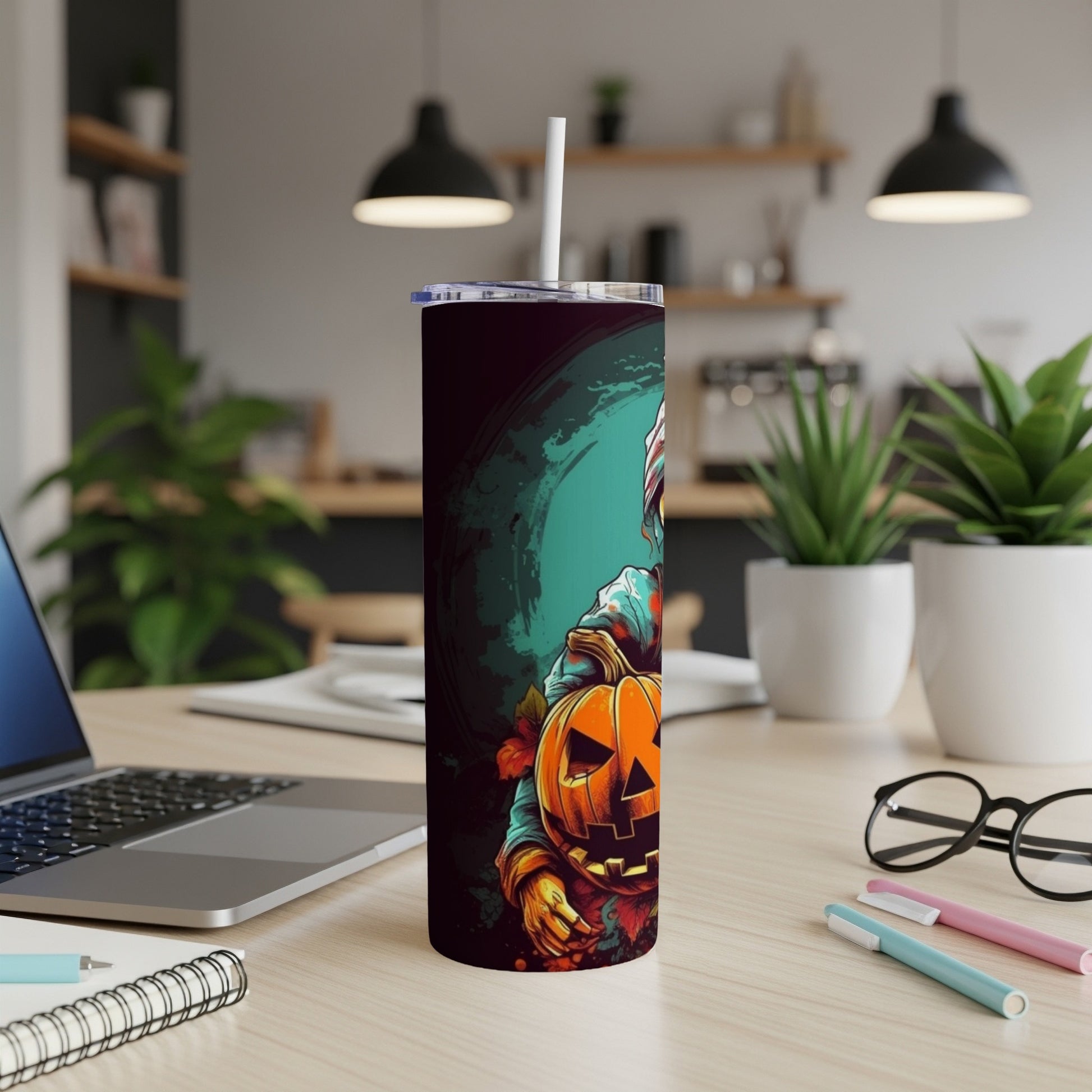Tall tumbler with Halloween scarecrow and jack-o'-lantern illustration and white straw.