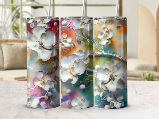 Three tumblers with white floral and pearl embellishments on a colorful background.