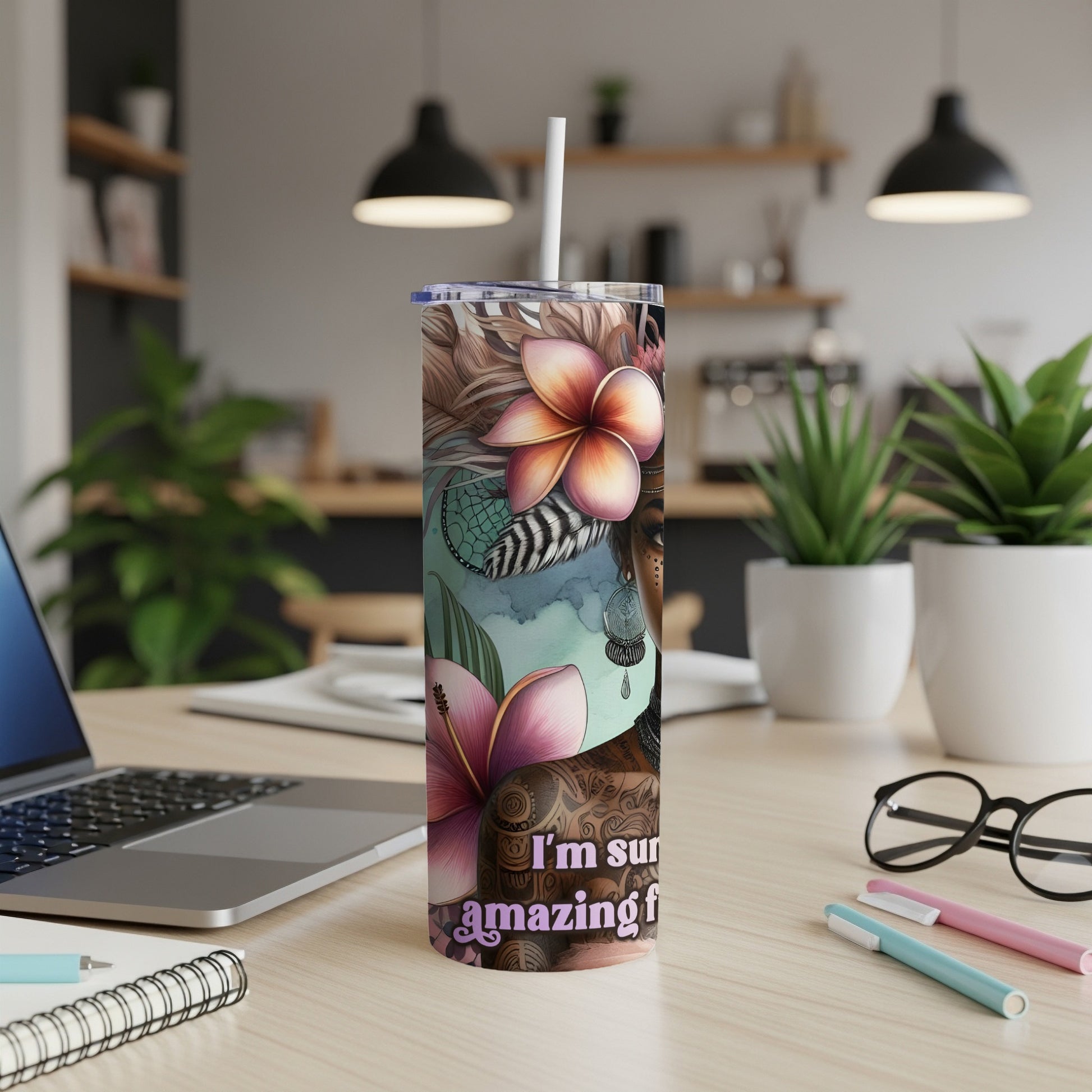 Tumbler with floral and feather designs featuring a woman's silhouette.