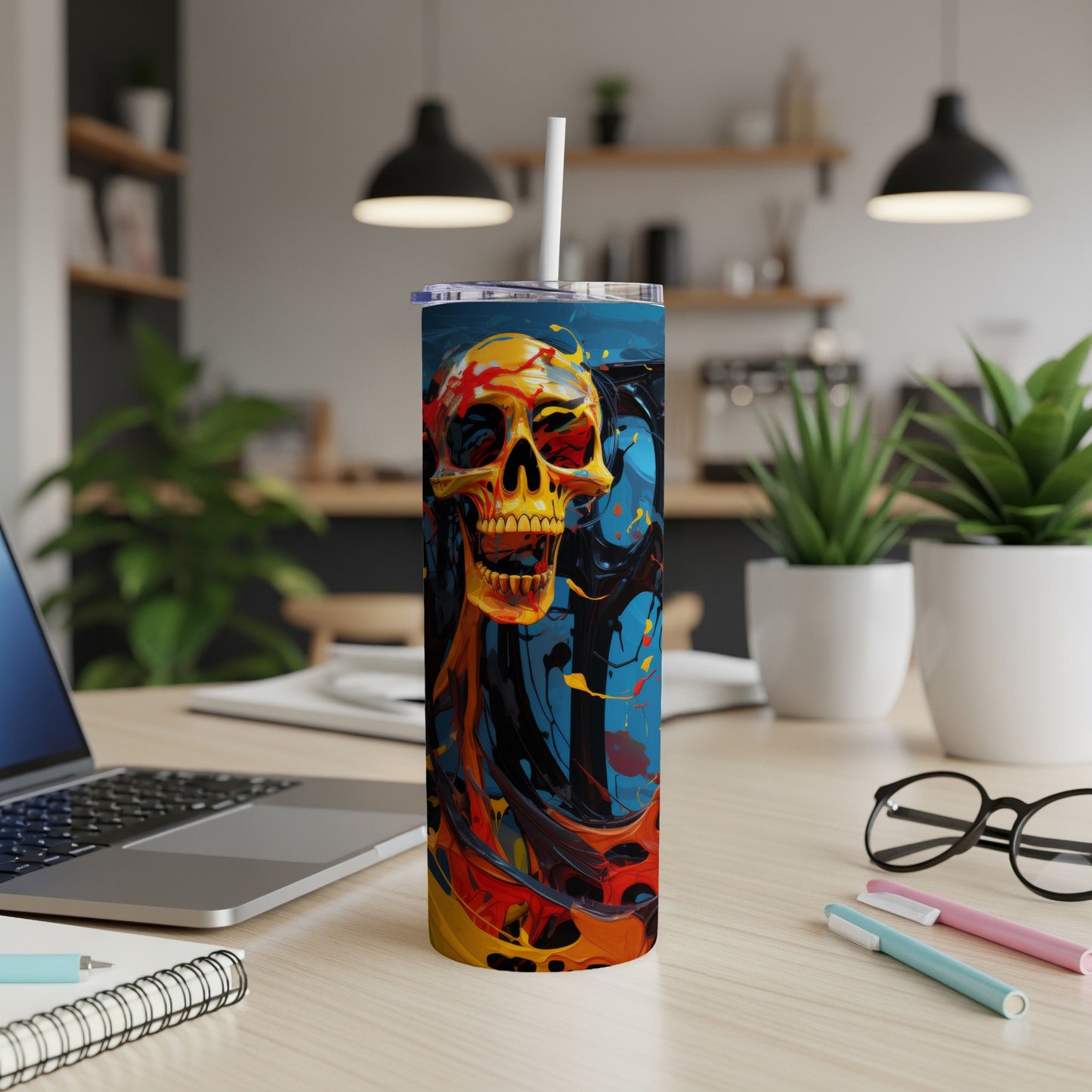 Tall tumbler with a yellow, red, and black abstract skull design.