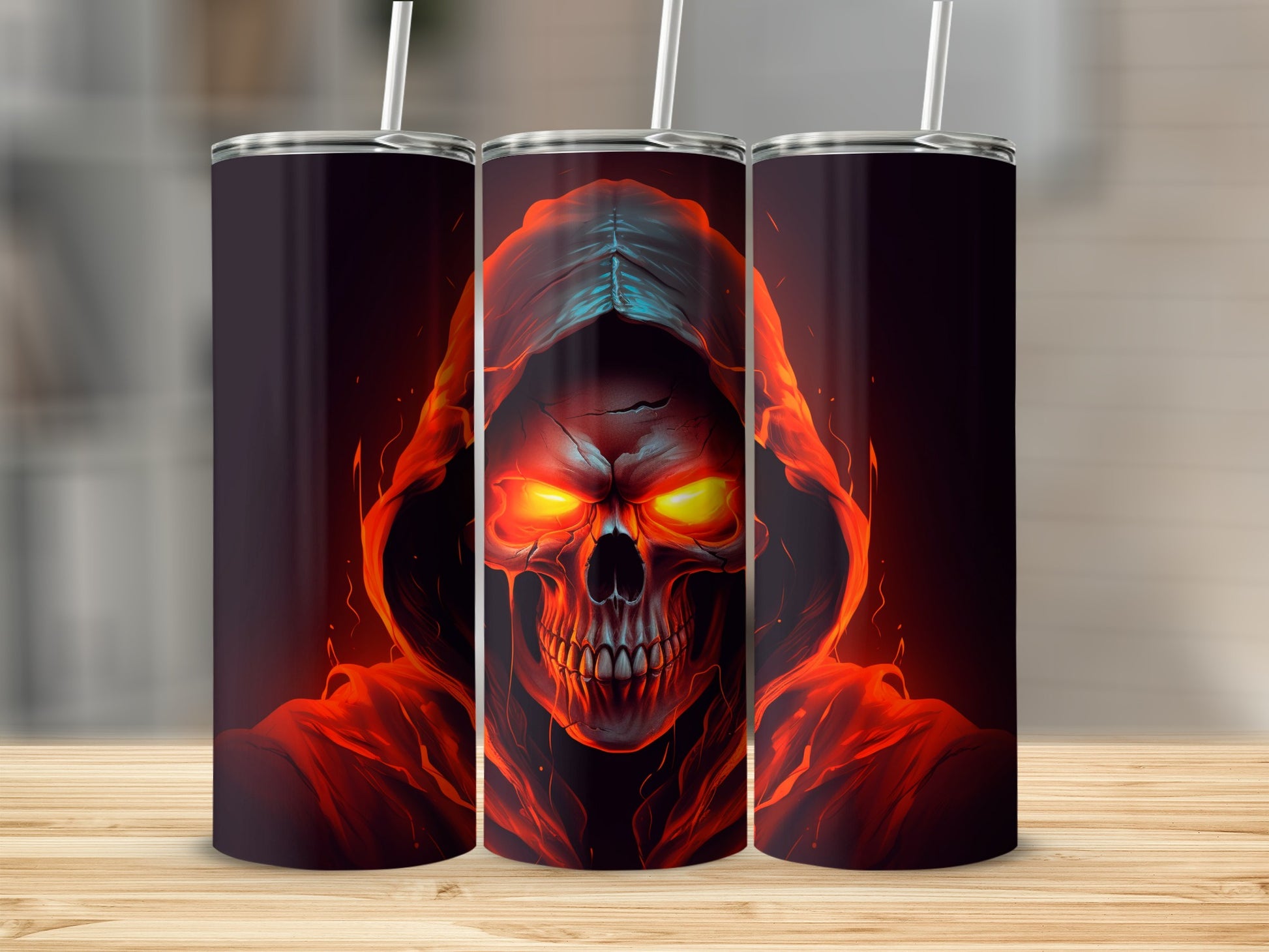 Three tumblers with a flaming skull design, one in the center.