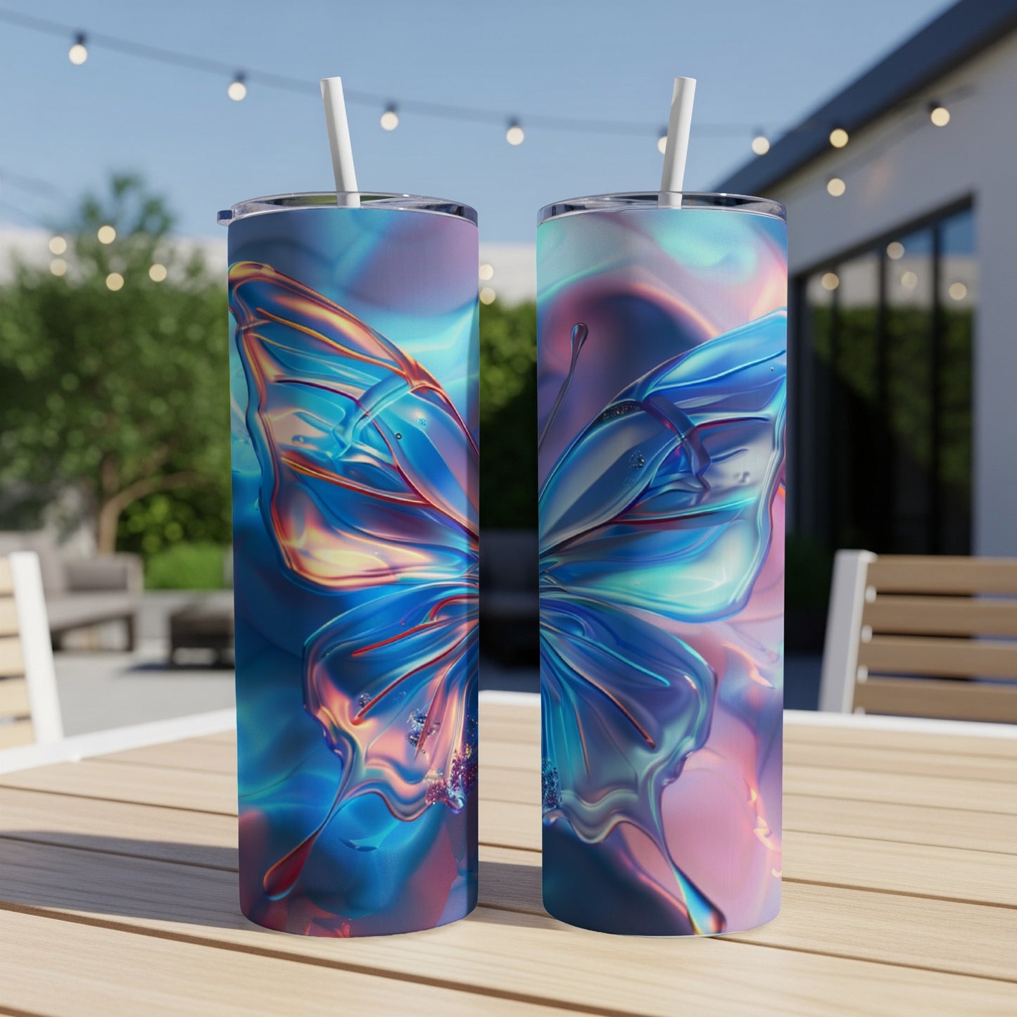 Two iridescent butterfly tumblers on a table outdoors.