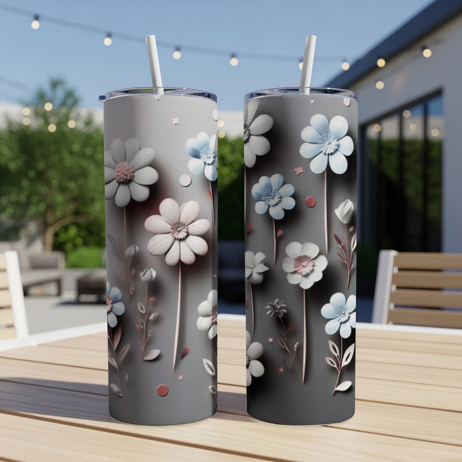 Two tumblers with a gray background and delicate floral designs in white and pale blue.