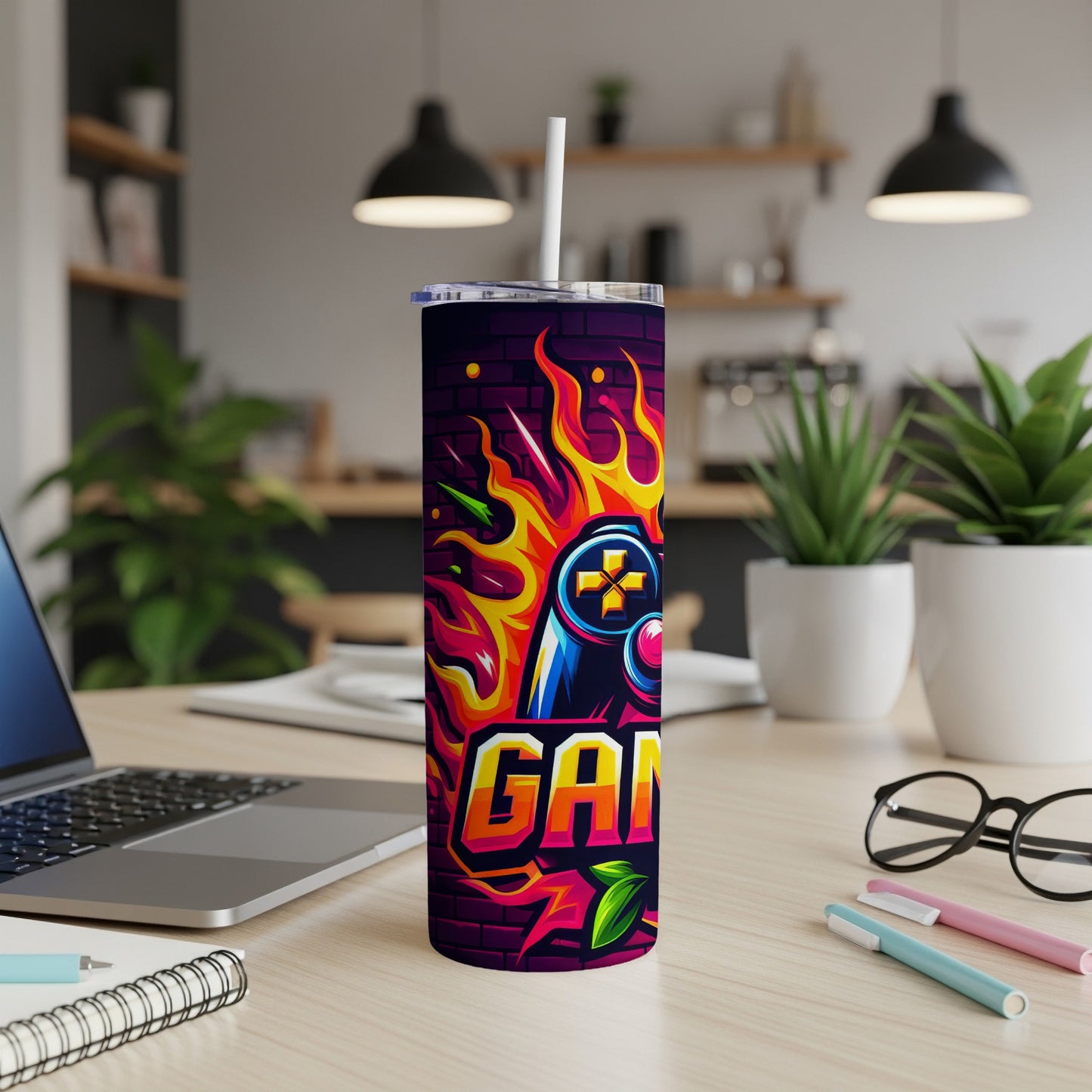 Tumbler with colorful "GAMER" text and controller on fire.