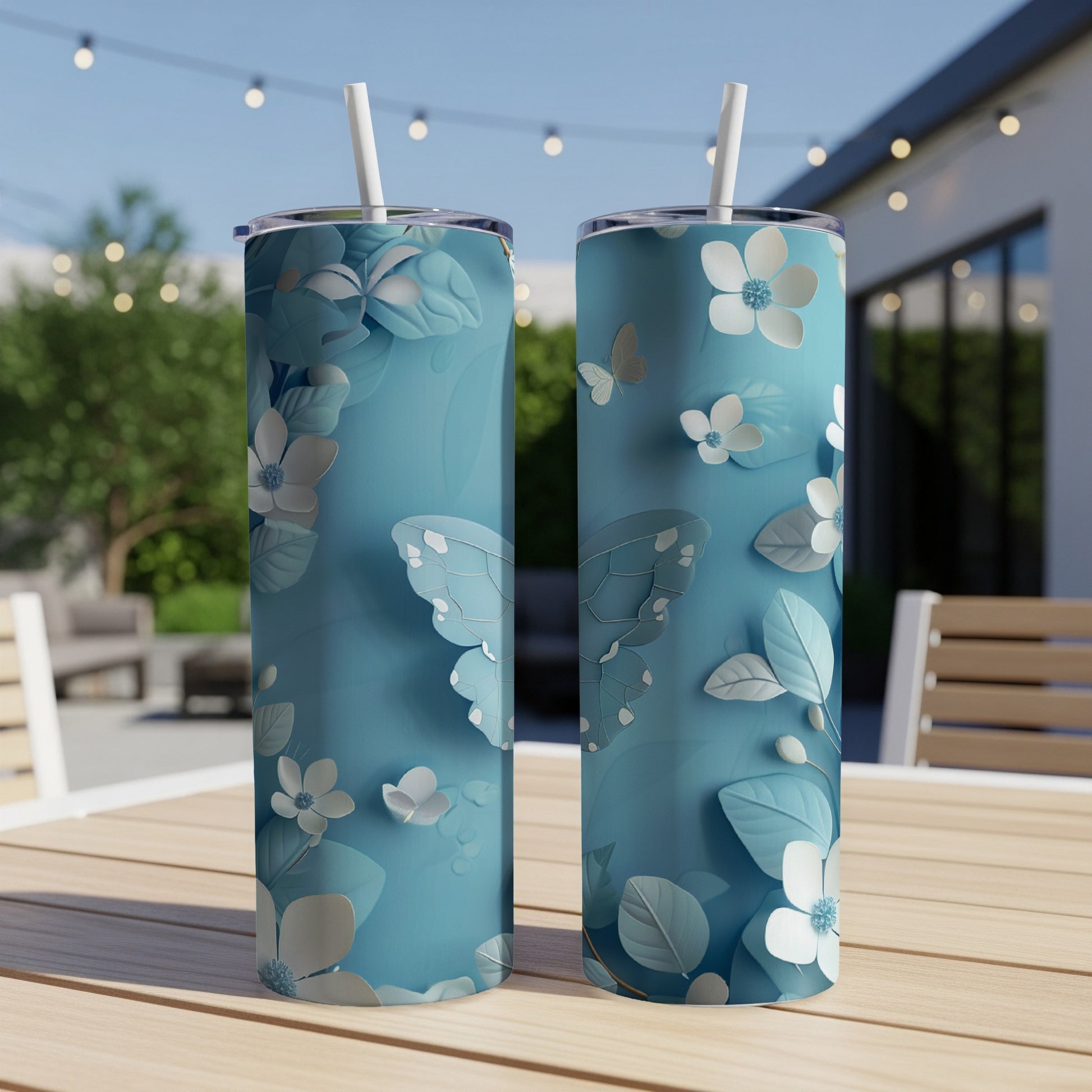 Two light blue tumblers with a raised white floral and butterfly design.