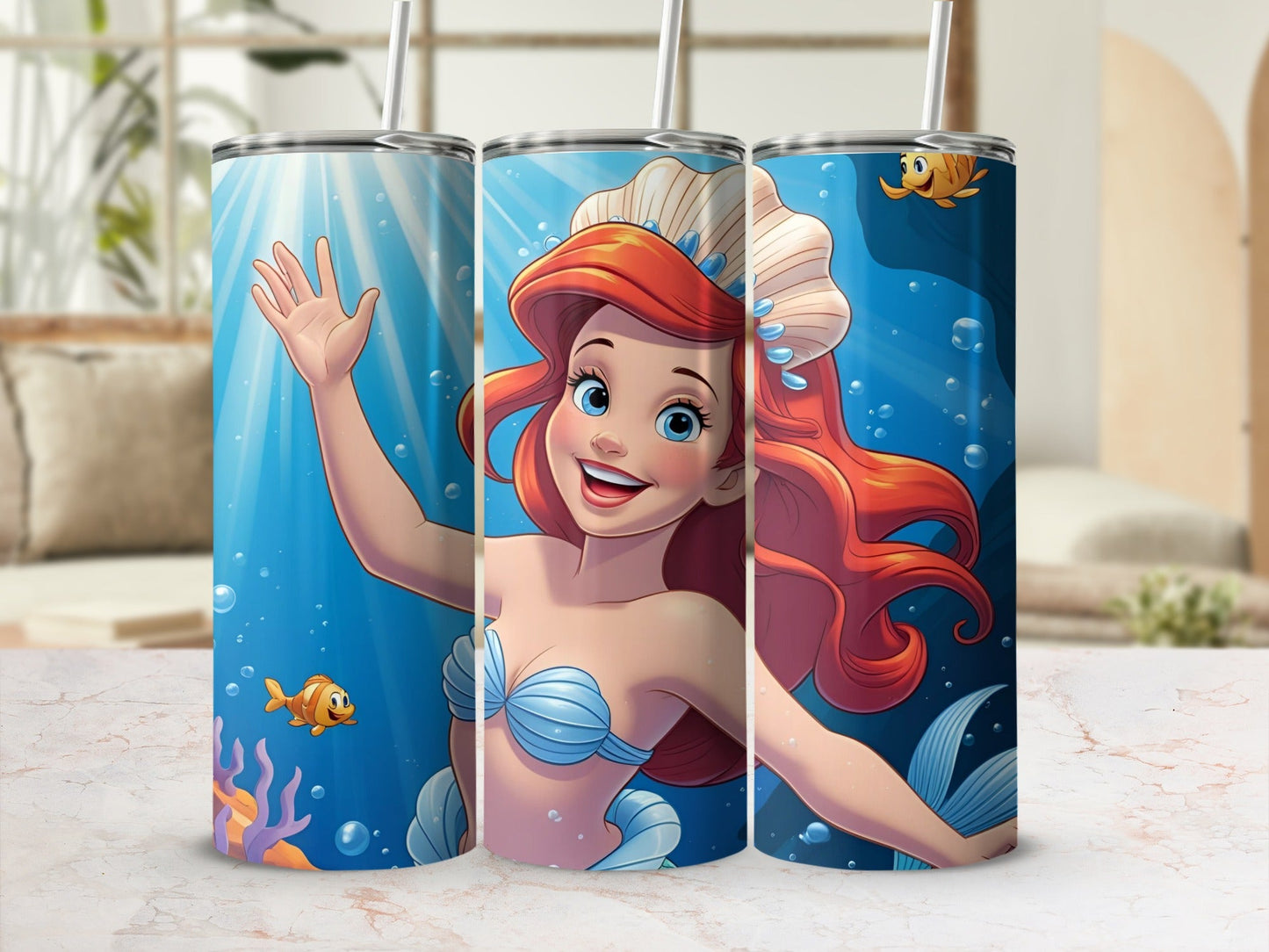 Ariel the mermaid smiles and waves, with fish and coral in the background.