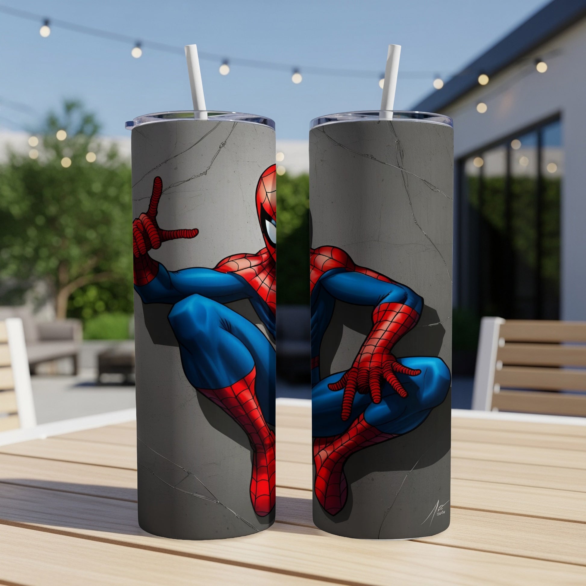 Spiderman peeking around a cracked wall on two blue tumblers with straws.