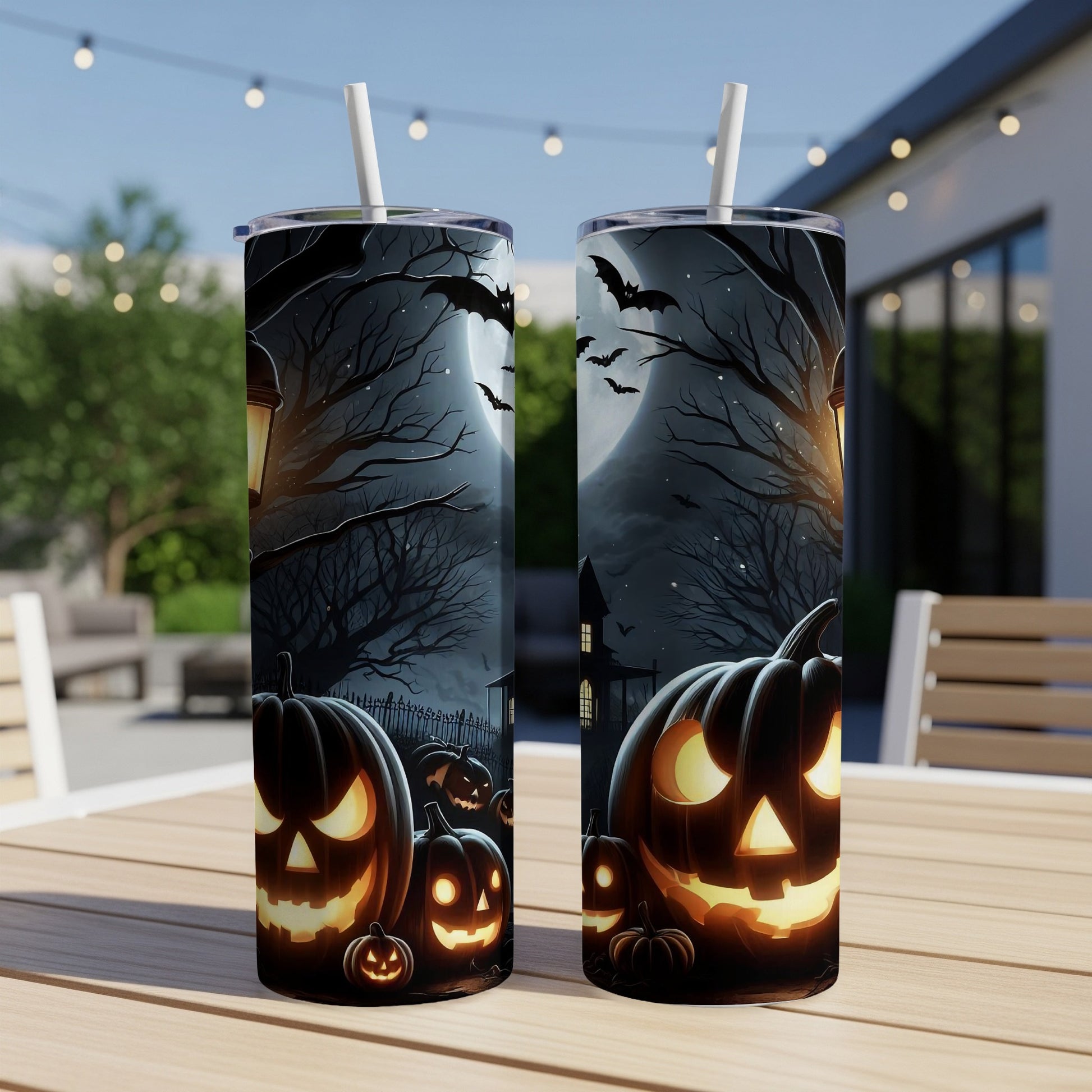 Two Halloween tumblers with glowing jack-o'-lanterns, bats, and spooky trees.