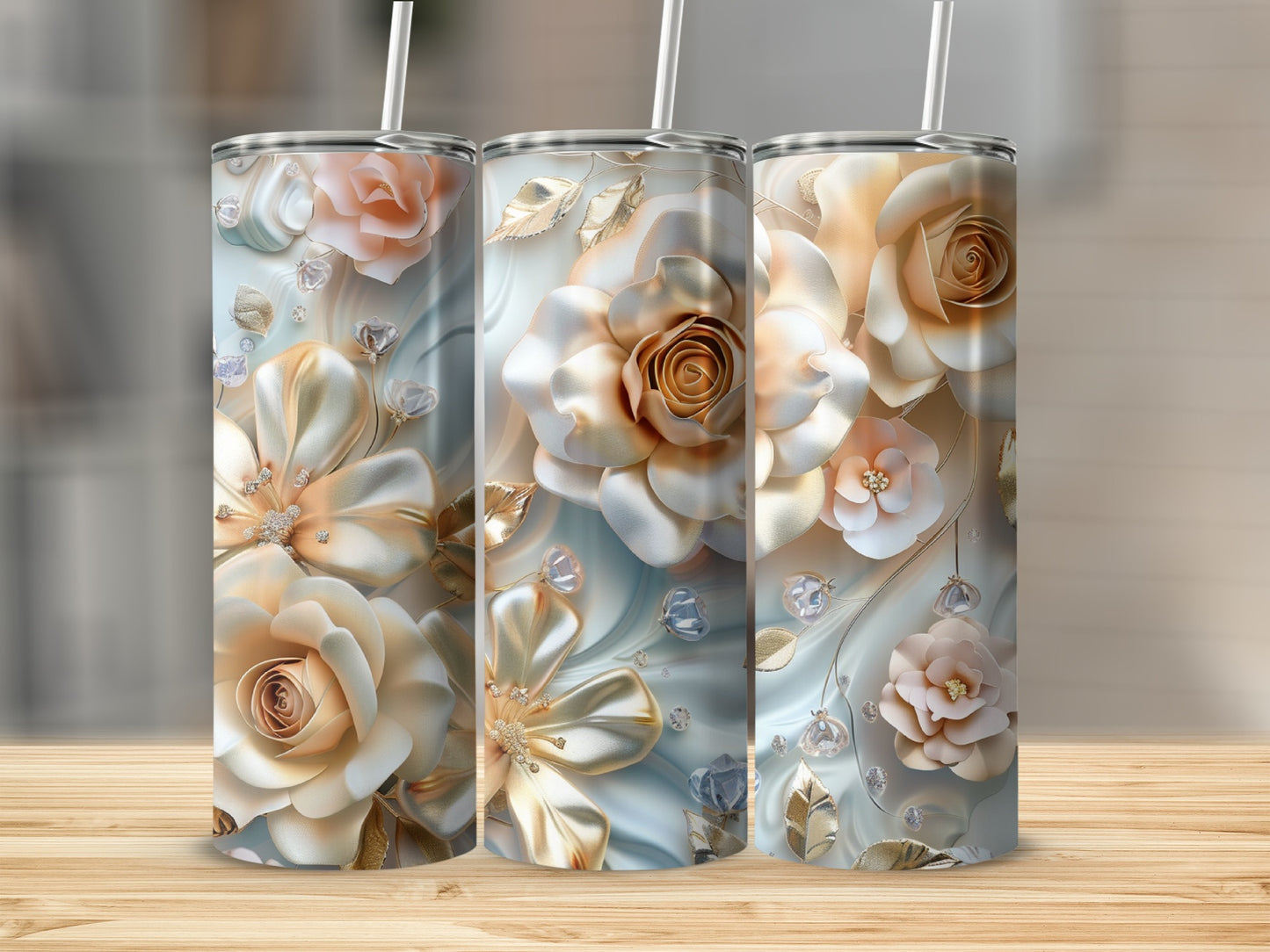 Three tall tumblers with ornate floral and jewel embellishments.