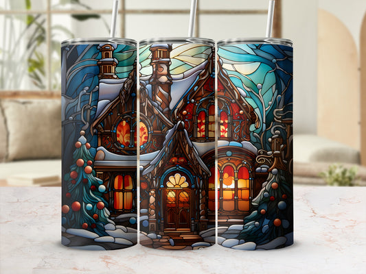 Stained glass tumbler with winter cottage, snow-covered trees, and warm glowing windows.
