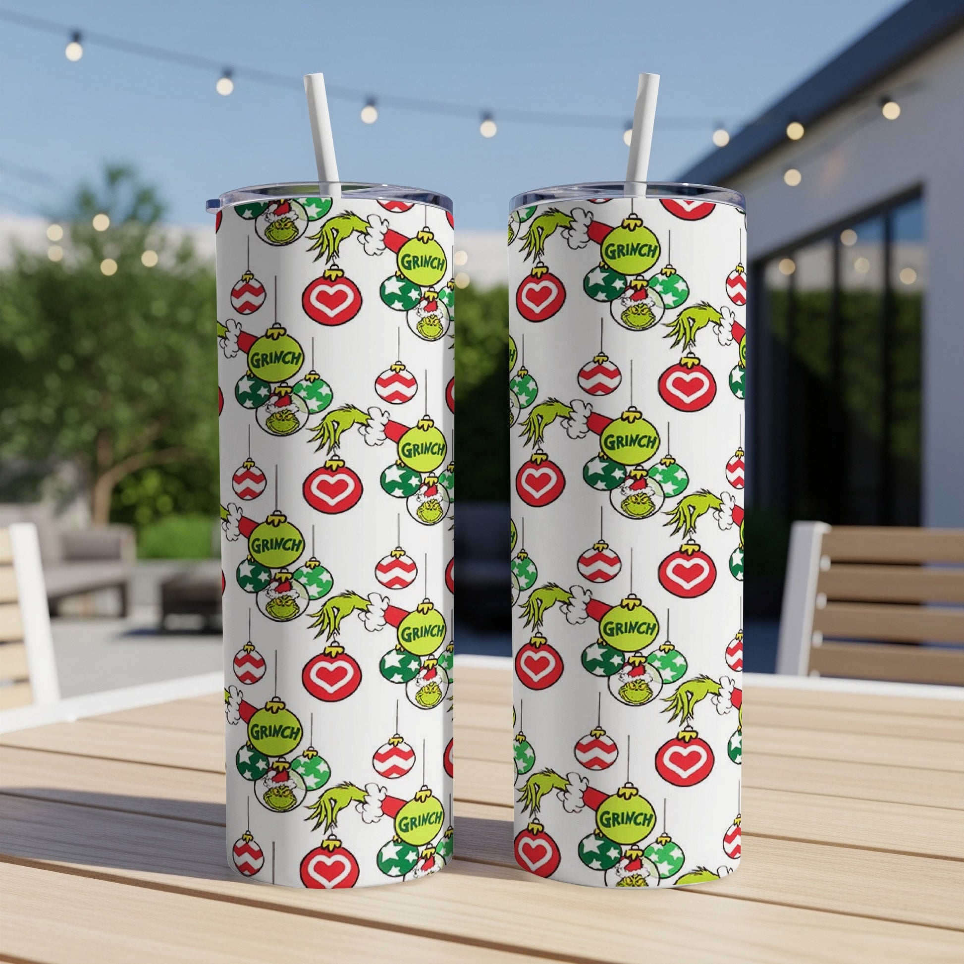 Two tumblers with a Grinch Christmas ornament pattern.