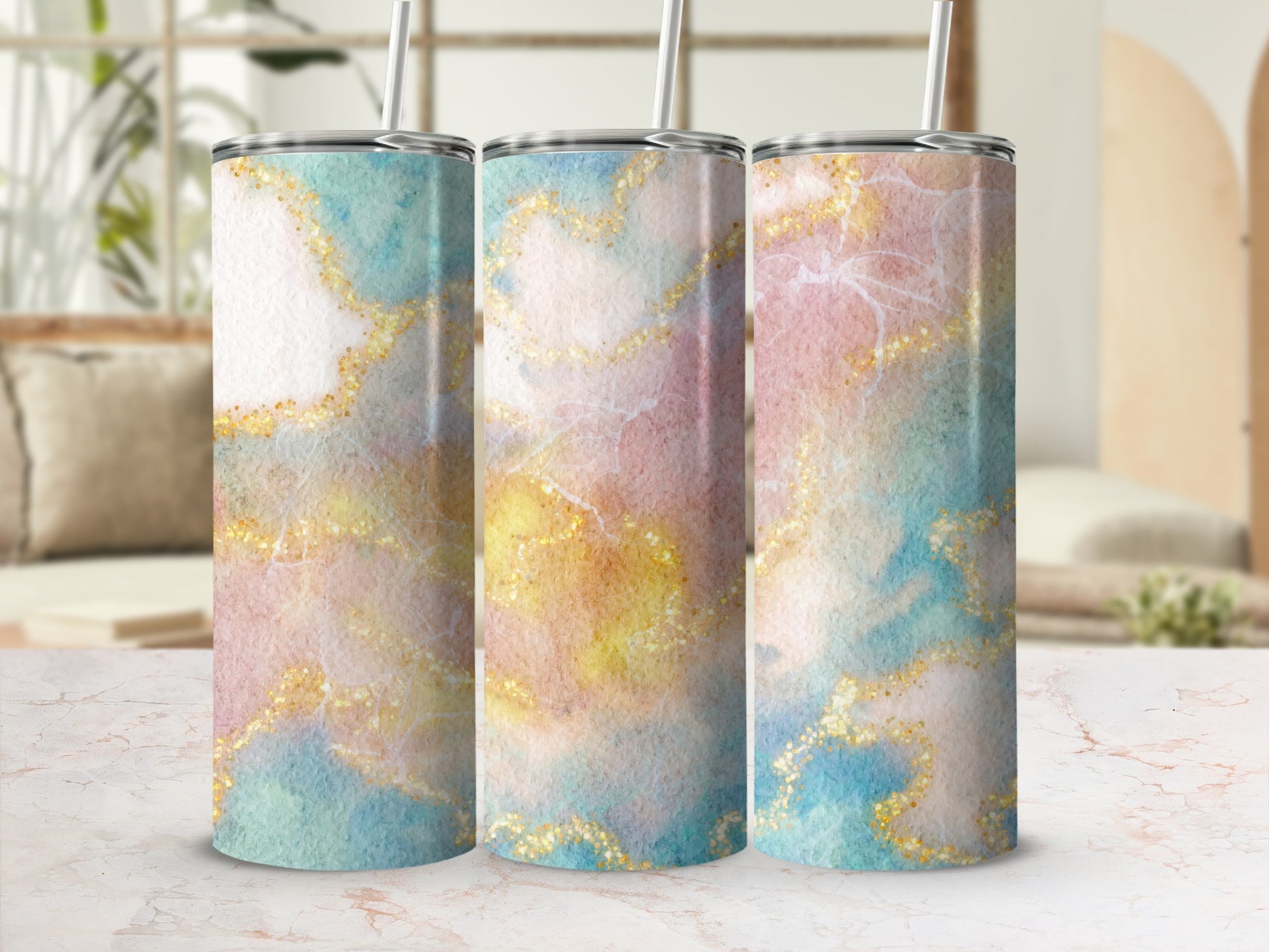Three tumblers with watercolor marble and glitter patterns in pastel colors.