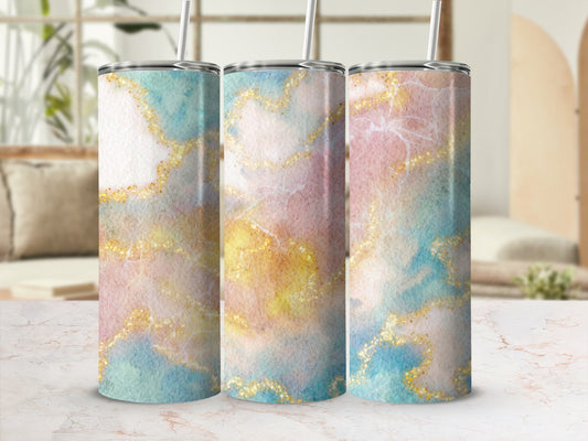 Three tumblers with watercolor marble and glitter patterns in pastel colors.