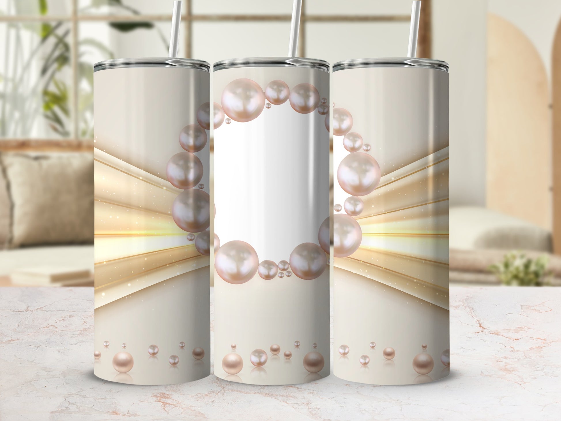 Three tumblers with pearl design and straw, on a marble surface.