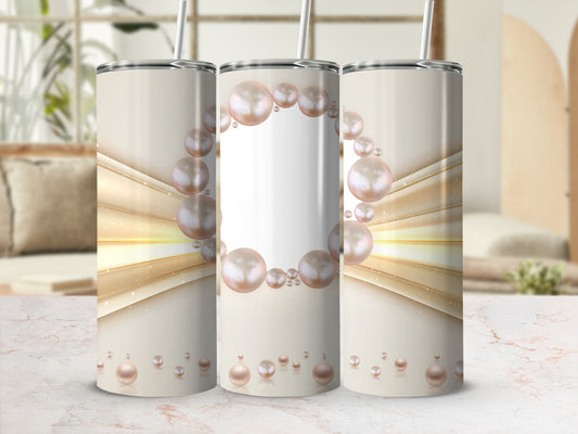 Three tumblers with pearl design and straw, on a marble surface.