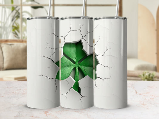 White tumbler with cracked design revealing a green shamrock.