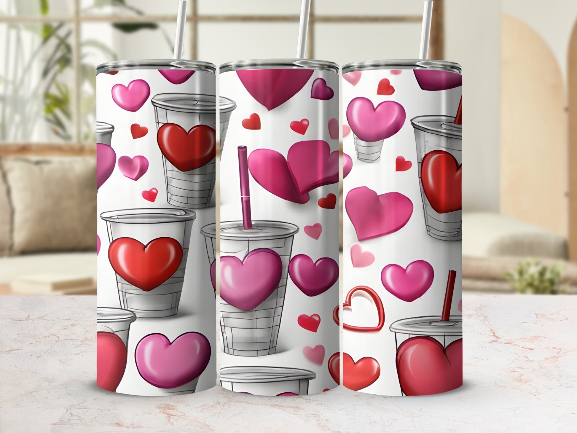 Three tumblers with a repeated heart pattern on a marble surface.