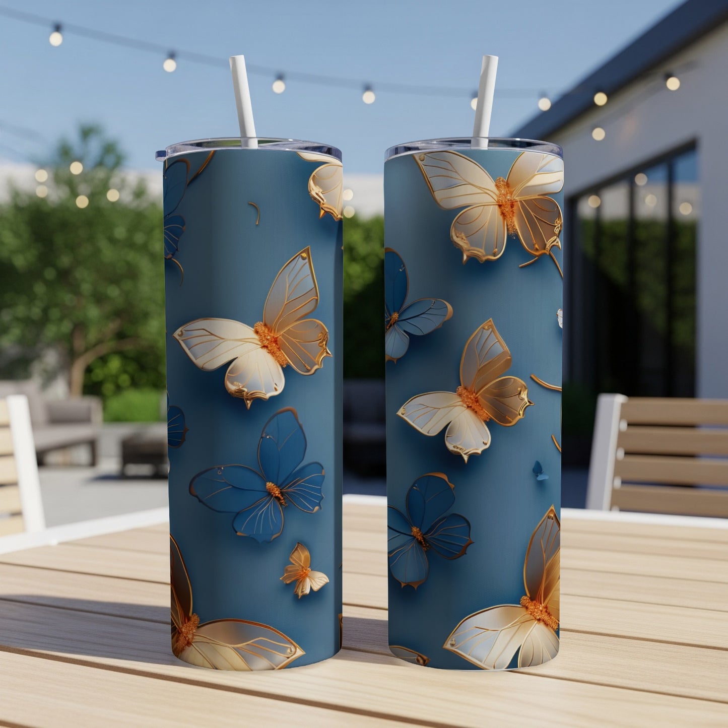 Two tall, blue tumblers with a repeating pattern of gold and blue butterflies.