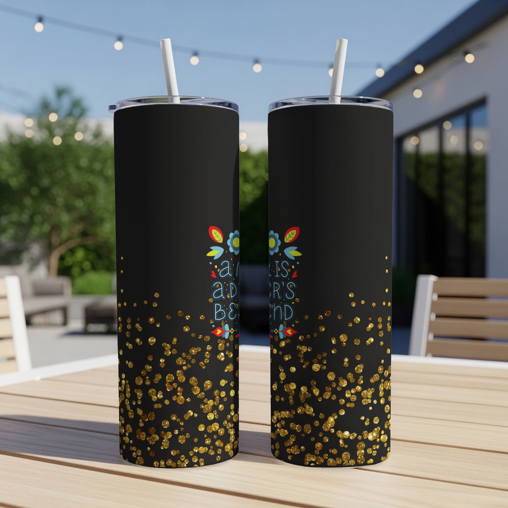 Black tumbler with gold glitter and colorful floral design.