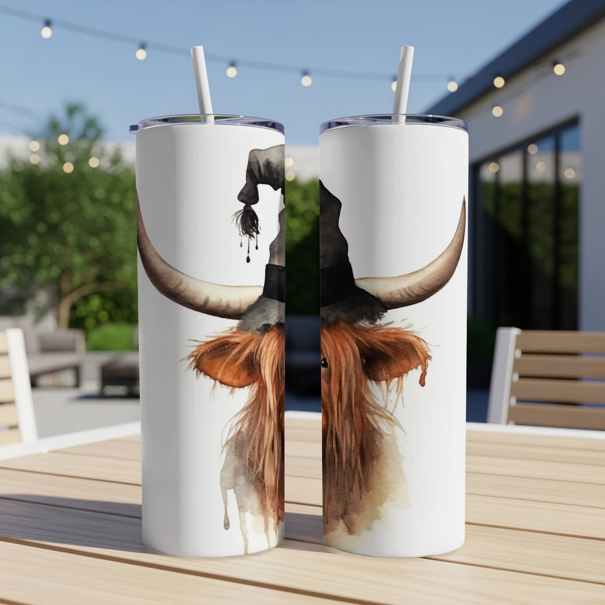 Watercolor highland cow wearing a witch hat on a white tumbler.