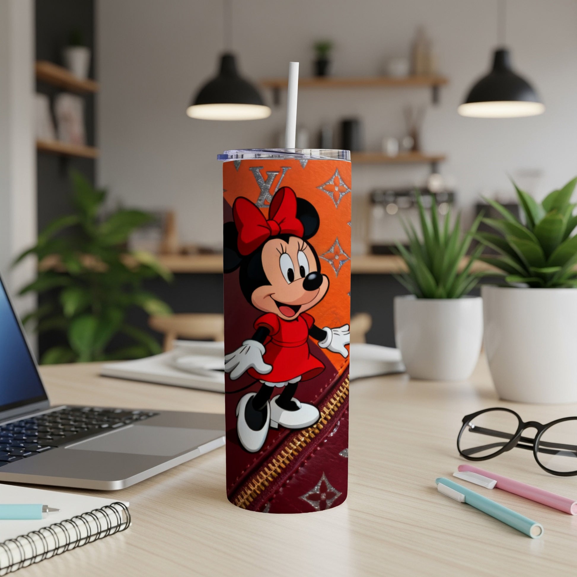 Minnie Mouse on a tumbler with a designer print and red bow.