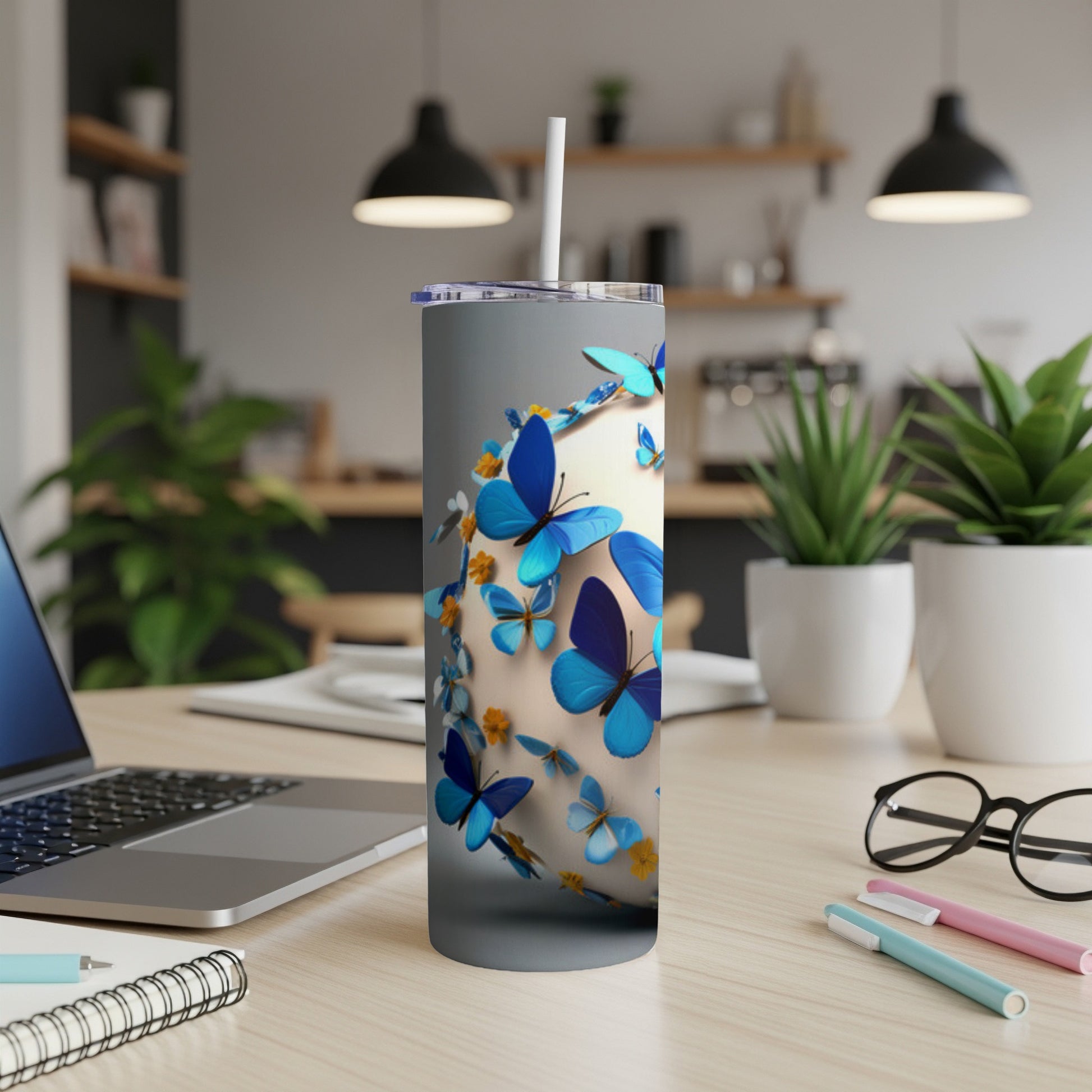 White tumbler with blue butterflies and yellow flowers.