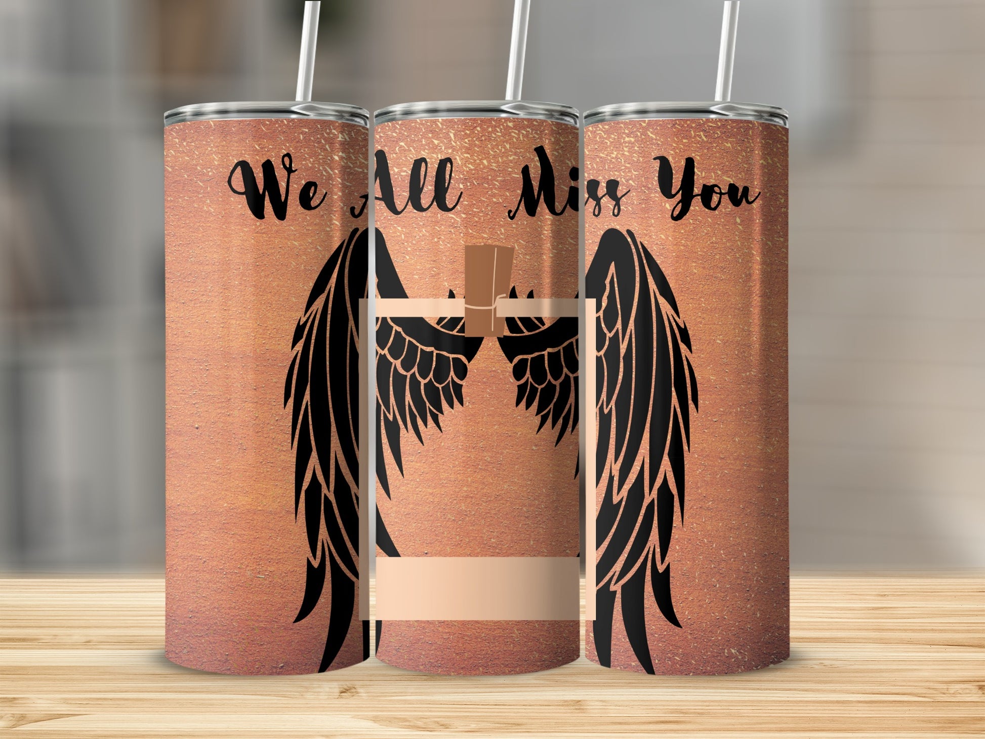 Three tumblers with black angel wings, a cross, and "We All Miss You" text.