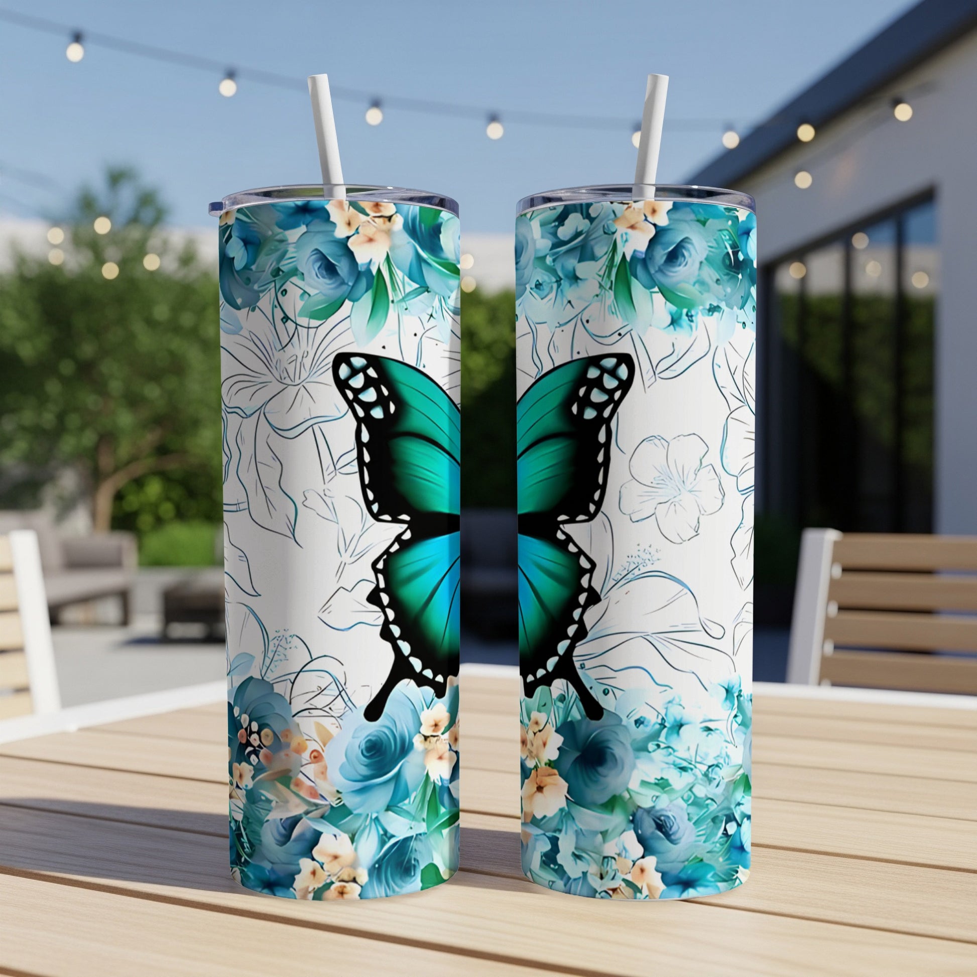 Two tumblers with a turquoise butterfly and blue floral design.