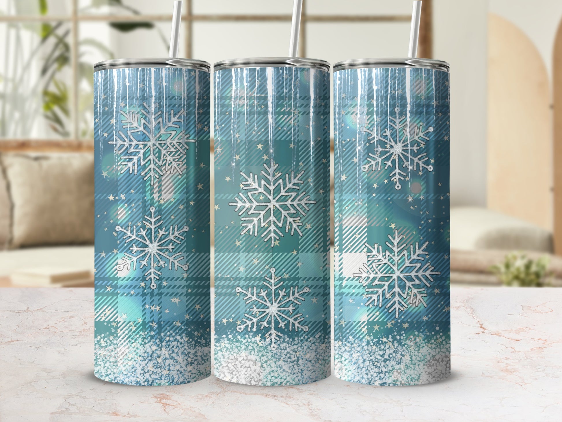 Three tall, skinny tumblers with blue plaid and glittery snowflakes.