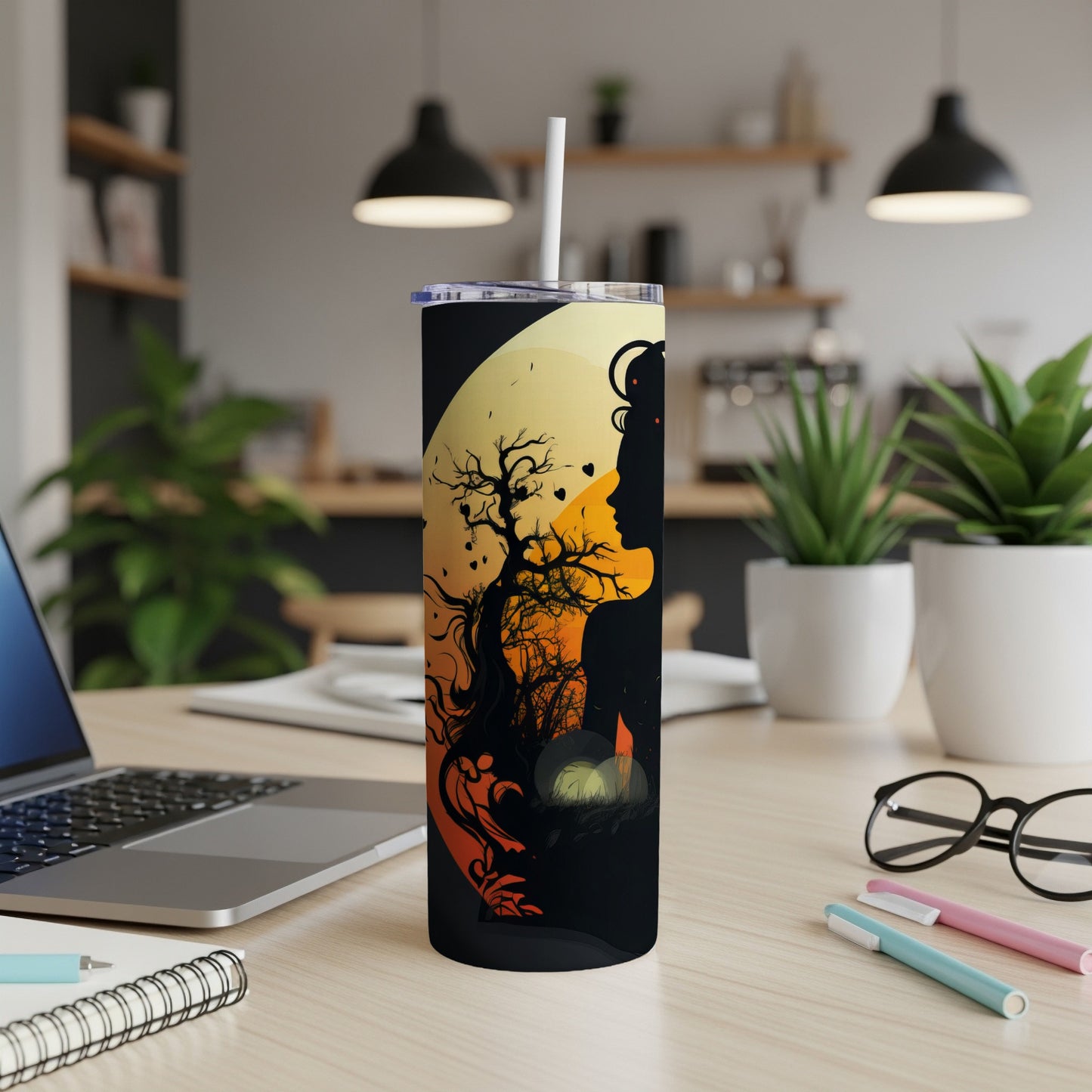 Tumbler with silhouette of a woman and a bare tree against a yellow moon.