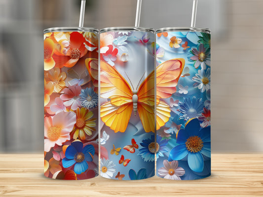 Three tumblers with floral and butterfly designs displayed on a wooden surface.