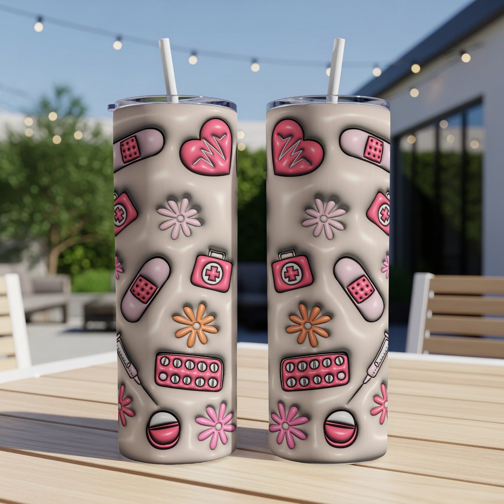 Two pink medical-themed tumblers with heart, bandage, and flower patterns.