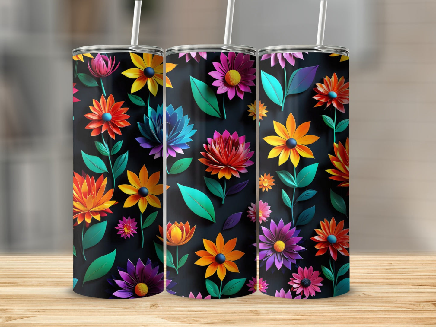 Three floral-patterned tumblers with vibrant flowers and dark backgrounds.