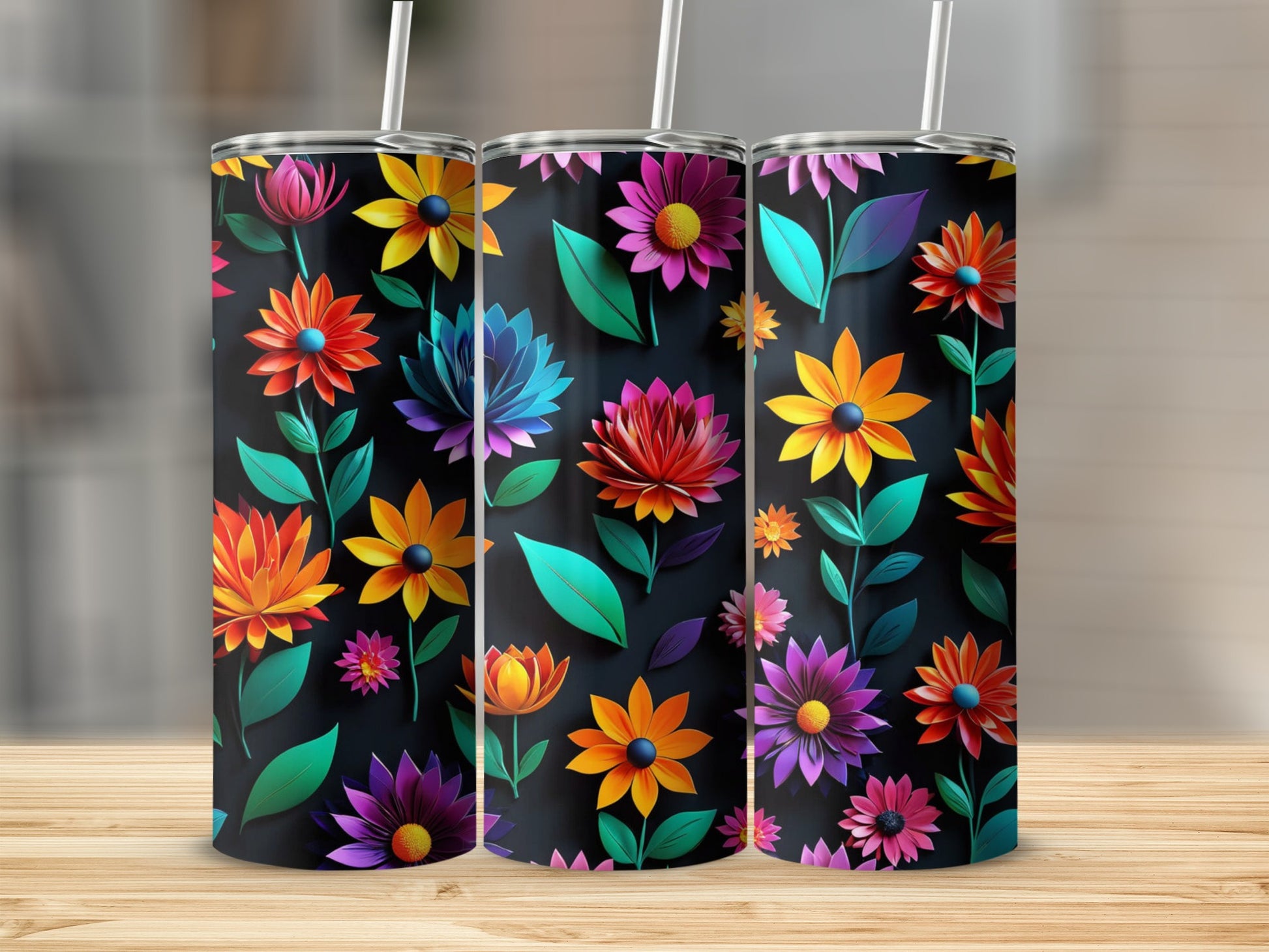 Three floral-patterned tumblers with vibrant flowers and dark backgrounds.