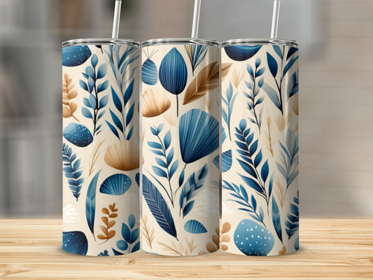 Three tumblers with a blue and tan botanical leaf pattern on a wooden surface.