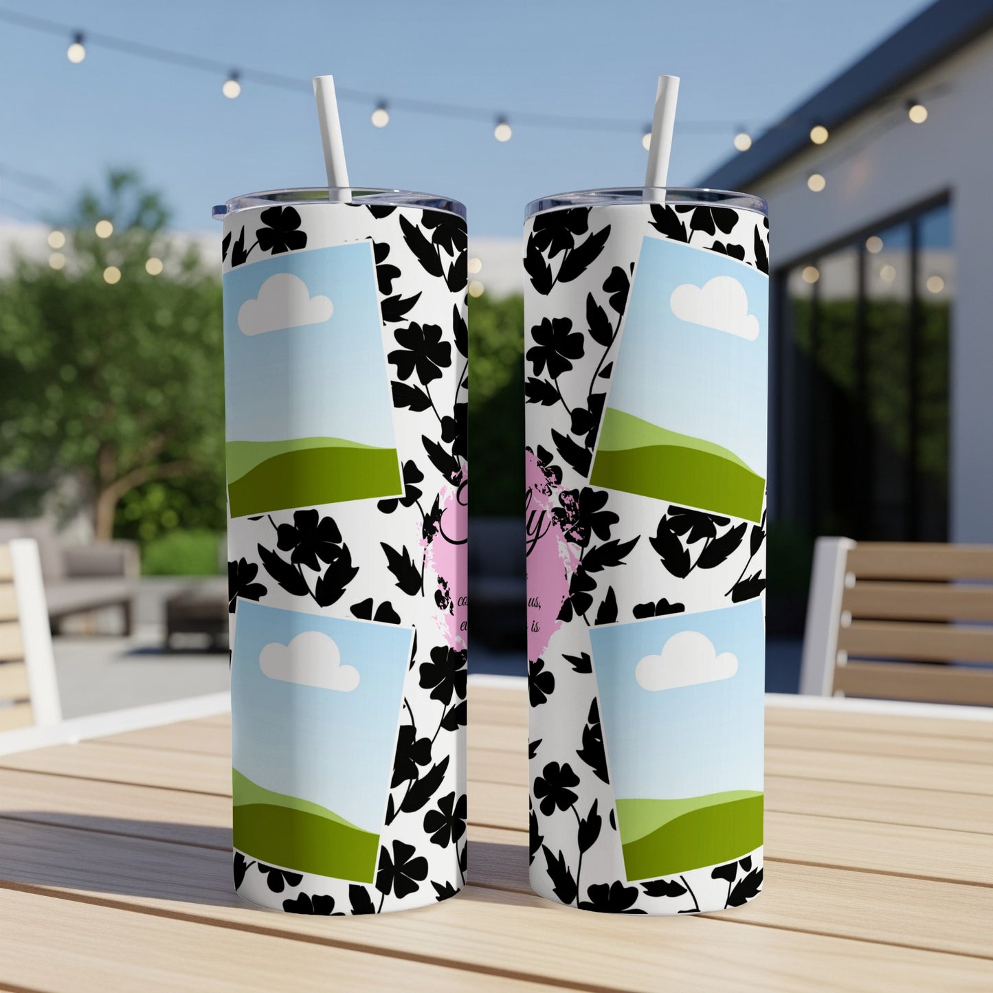 Two tumblers with floral pattern and landscape photos displayed outdoors.
