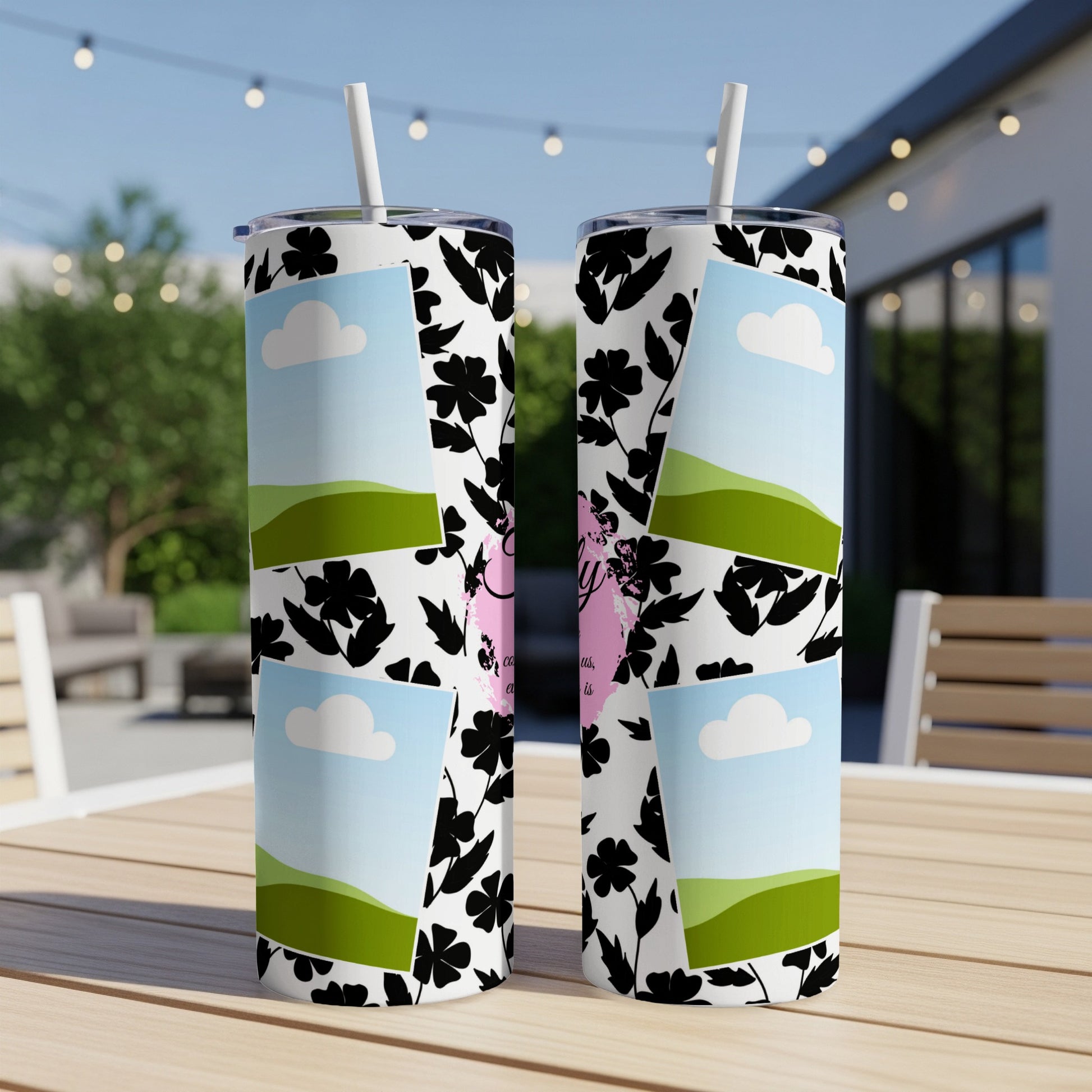 Two tumblers with floral pattern and landscape photos displayed outdoors.