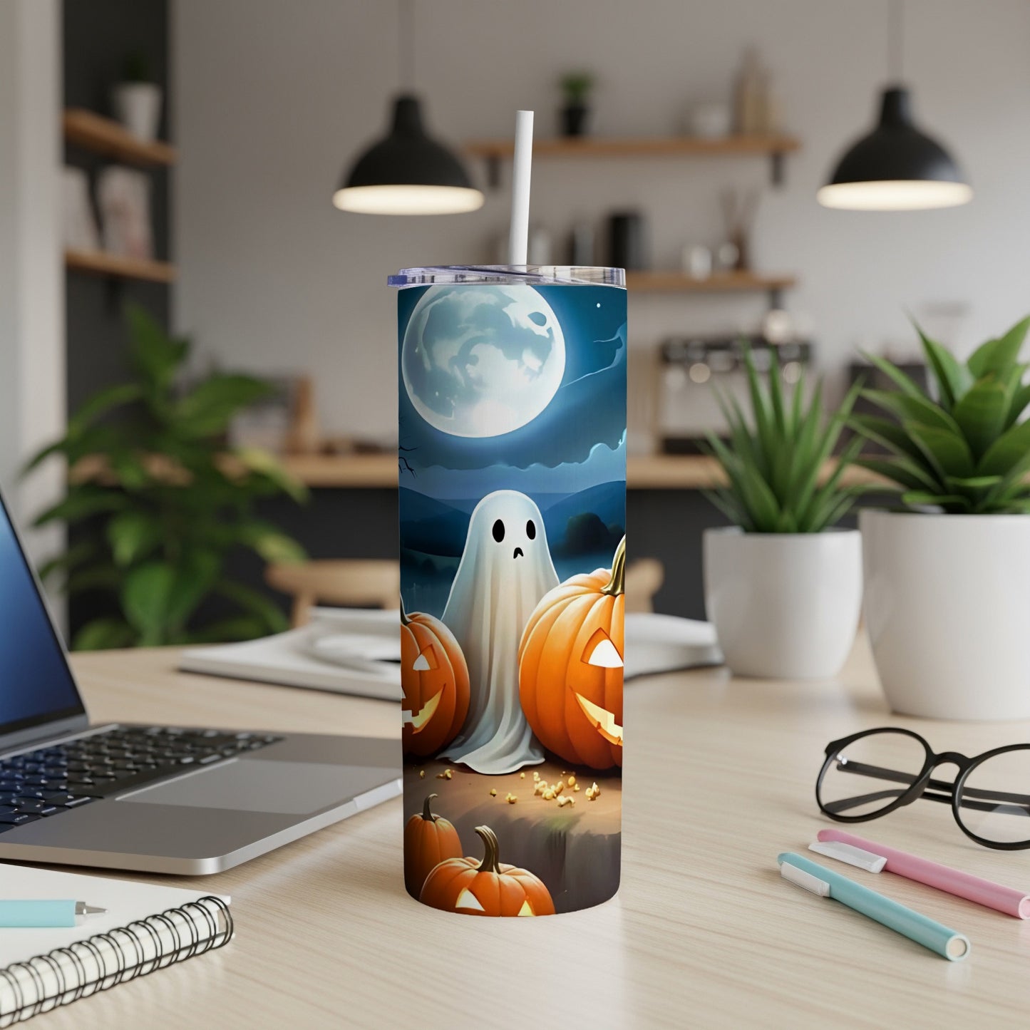 Tumbler with a ghost and pumpkins under a full moon Halloween design.