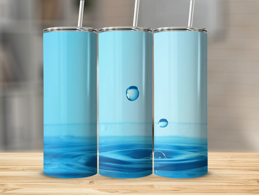 Three blue tumblers with water droplet graphics on a wooden surface.