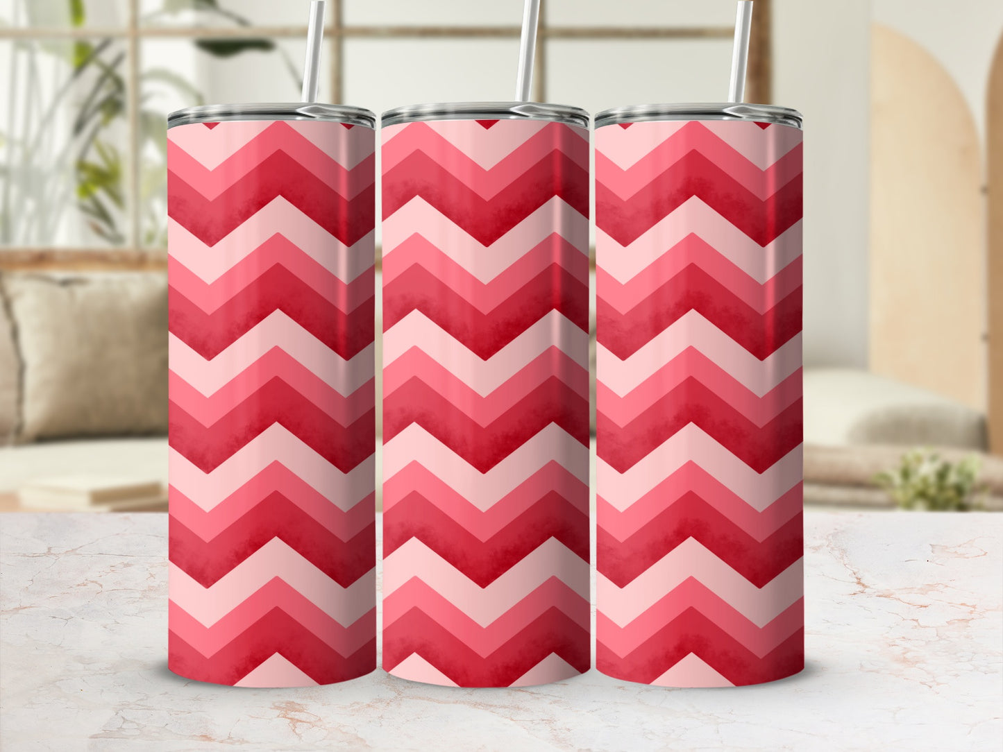 Pink and red chevron pattern insulated tumbler with straw.