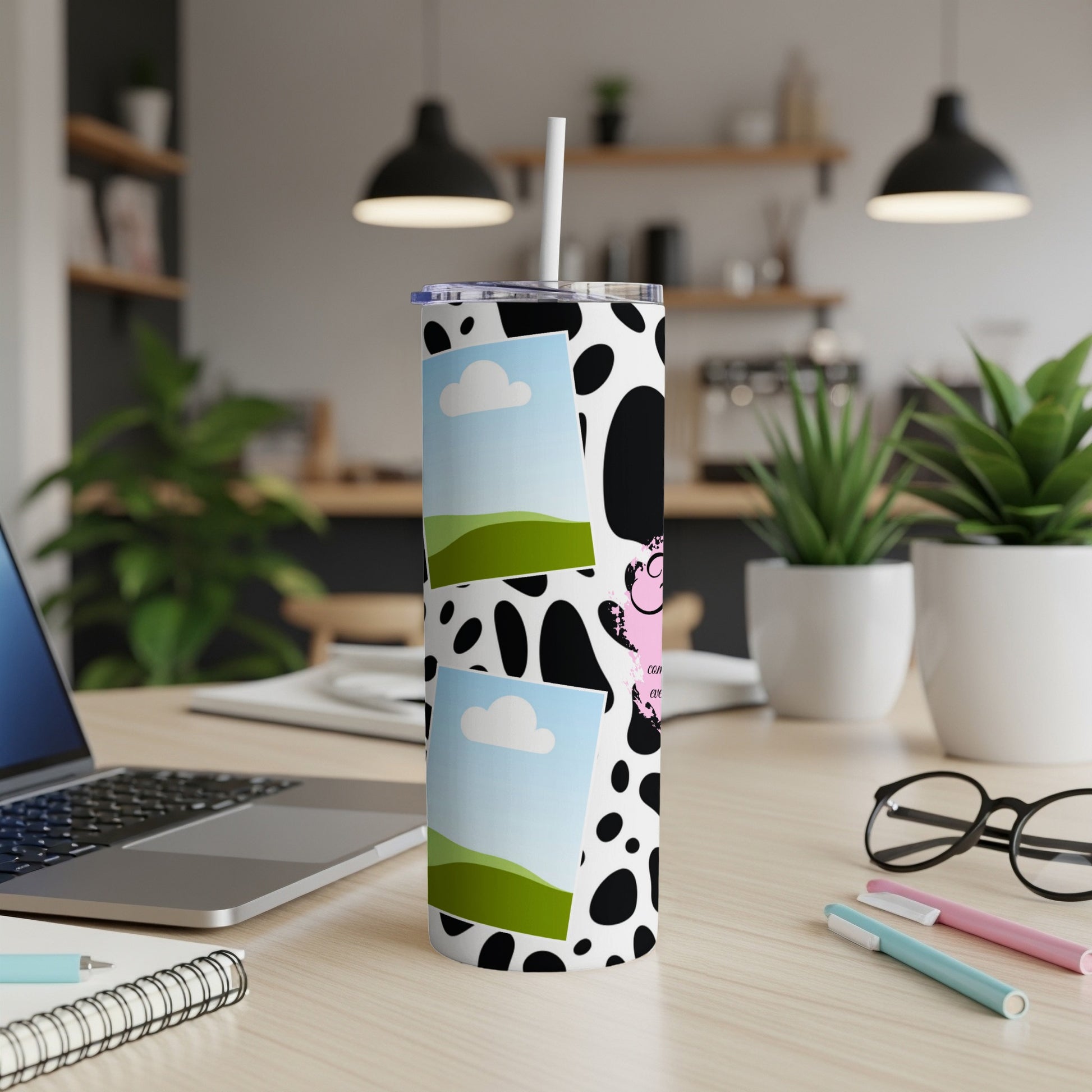 Tumbler with black and white cow print, featuring two photo frames and pink cartoon cow.