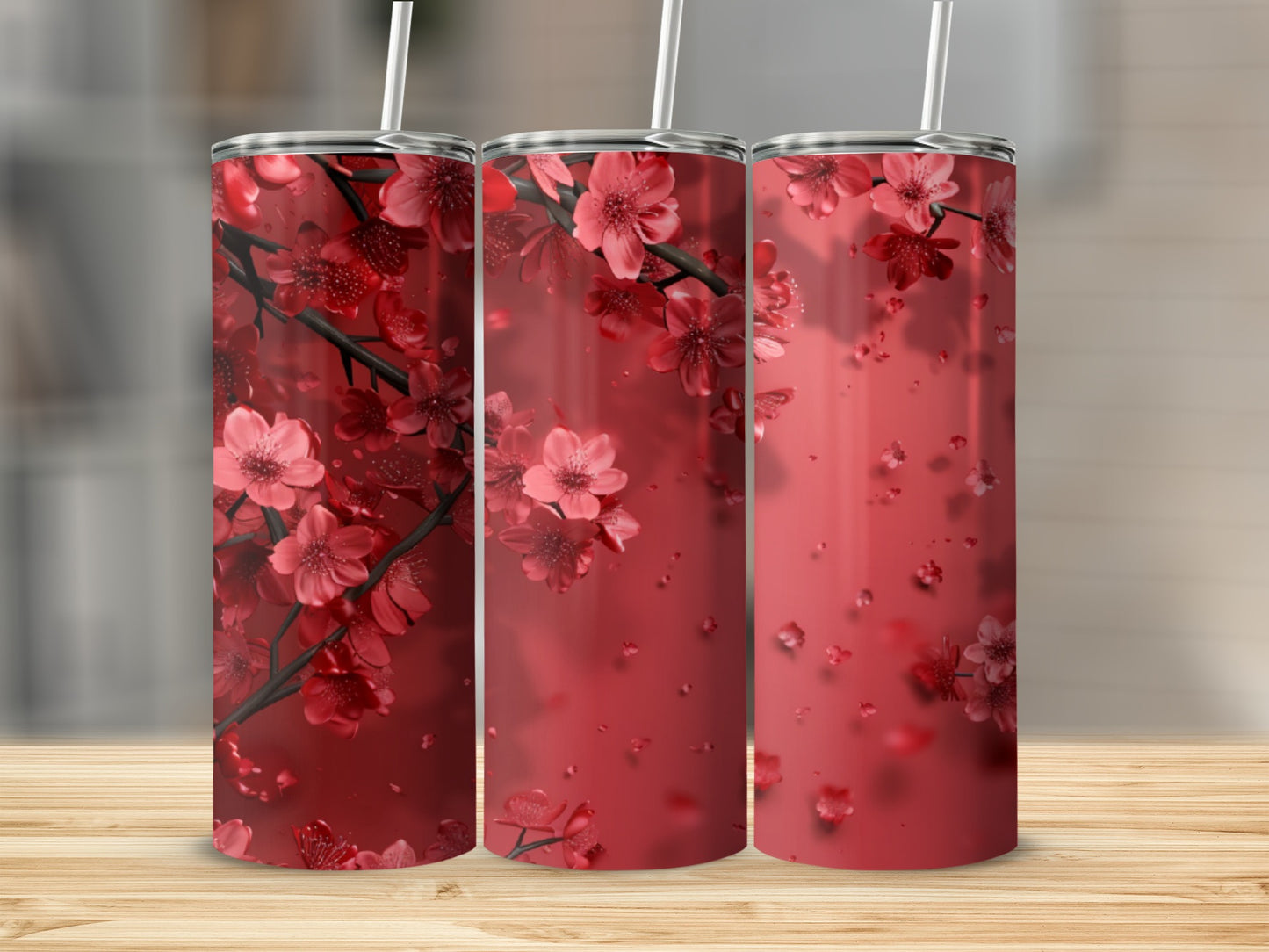 Three tumblers with red cherry blossoms against a red background.