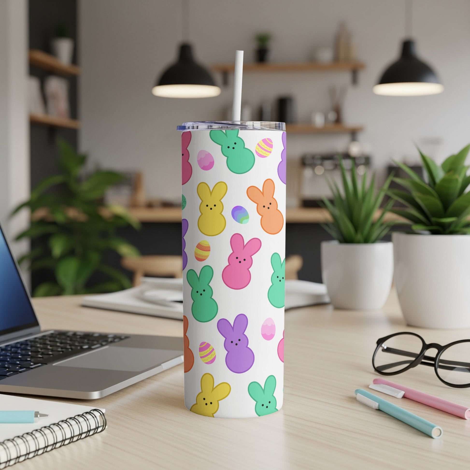 White tumbler with colorful Easter bunny and egg pattern.