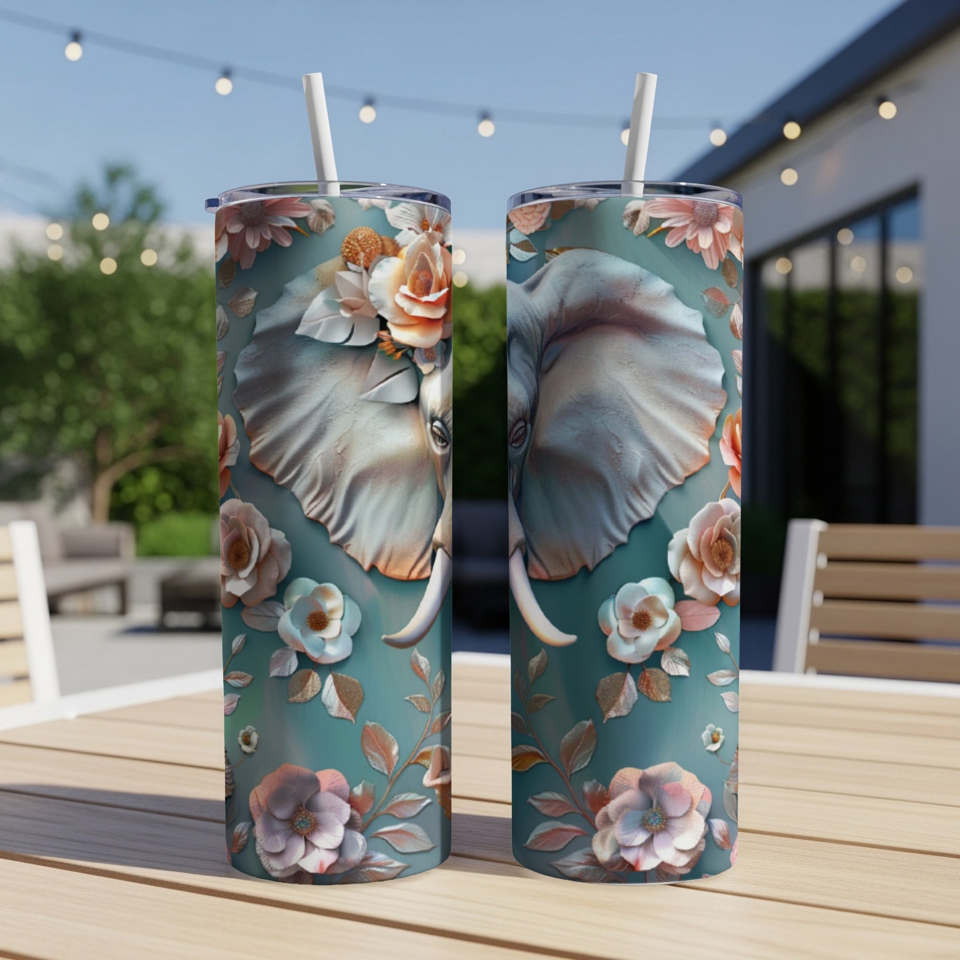 Two teal tumblers featuring a stylized elephant face with floral accents.