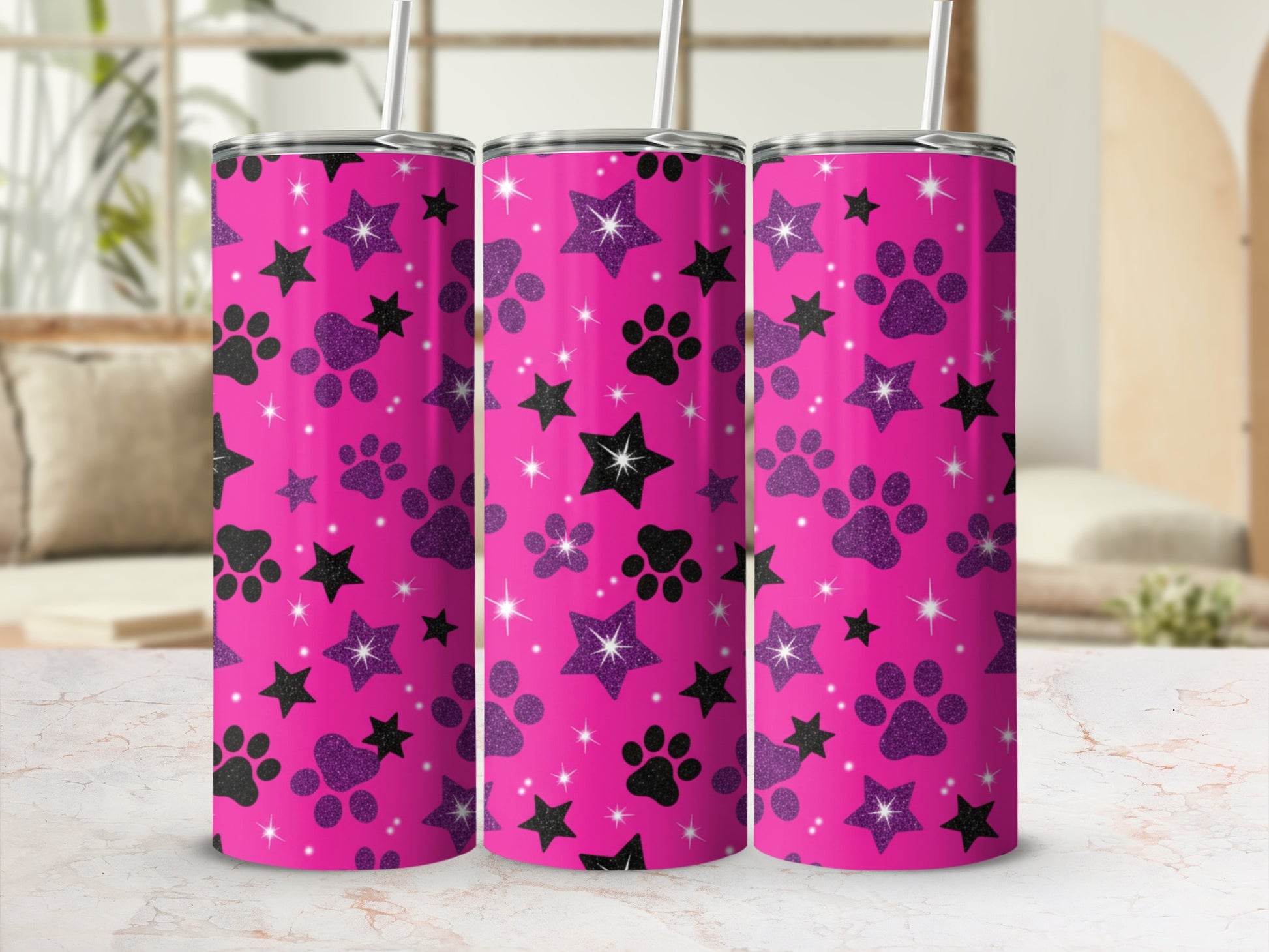 Three pink tumblers with black paw prints and purple glitter stars pattern.