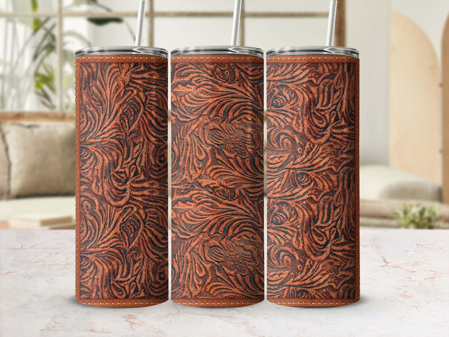 Three seamless faux leather patterned tumblers with straws.