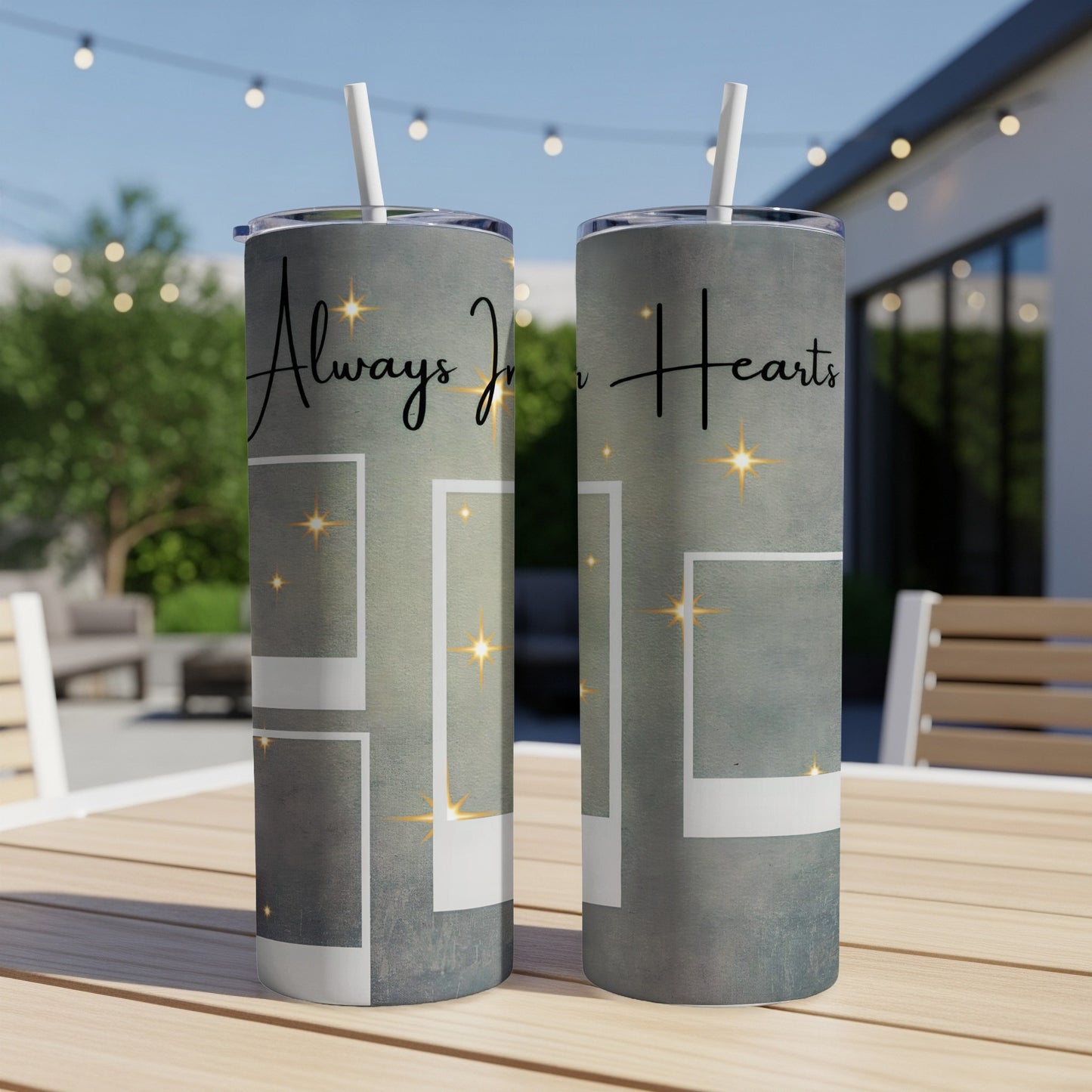 Two tumblers with "Always In Hearts" text and empty photo frames on a table.